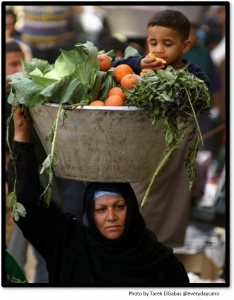 Woman holding basket of vegetables in Cairo